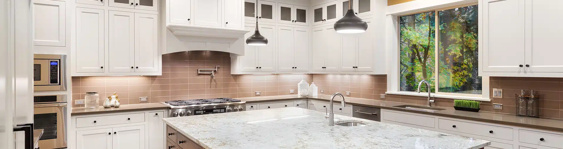 Professional kitchen remodeling with custom white cabinets and large island